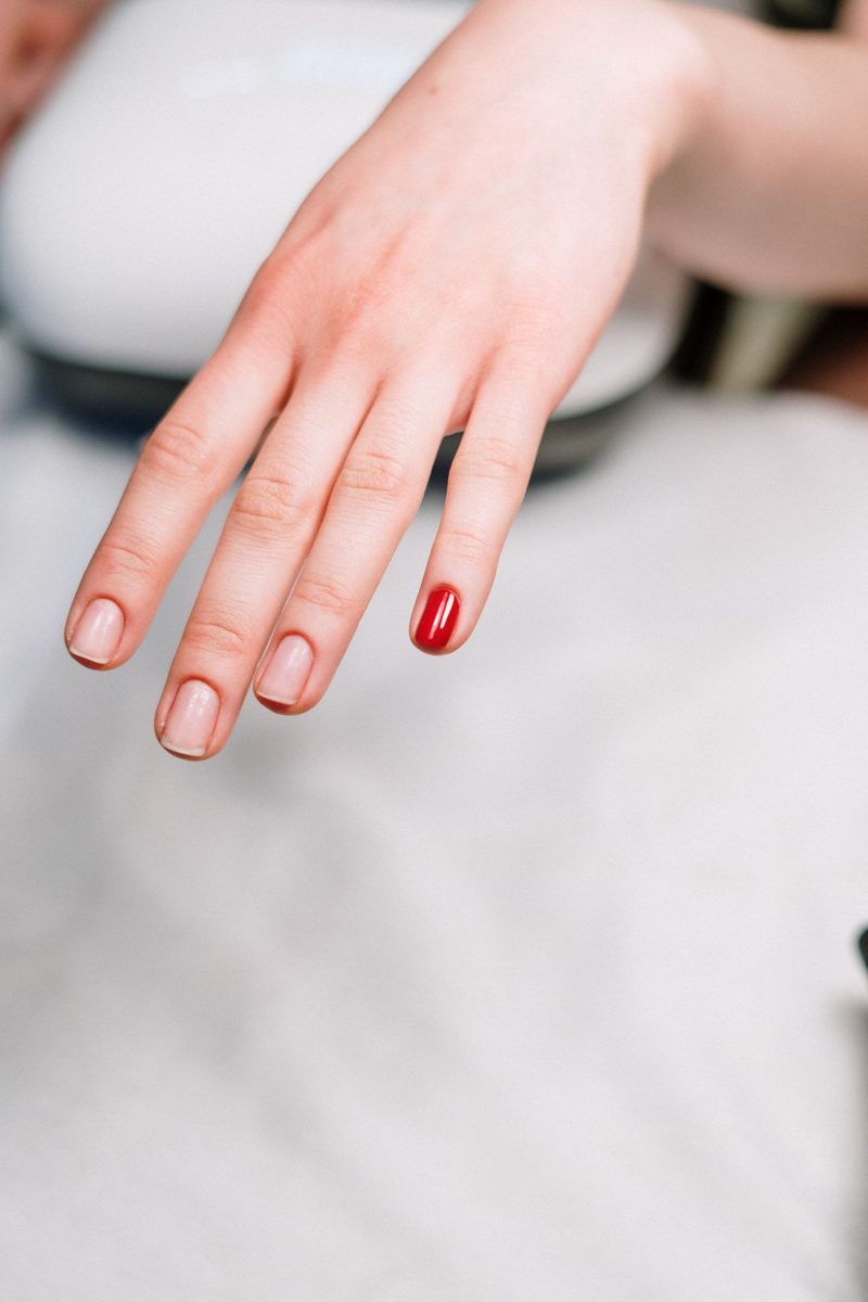 Hand resting on a table with red tips