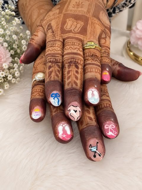 Hand-painted bow and heart nail art over bridal mehendi, by Nails by Ruhi