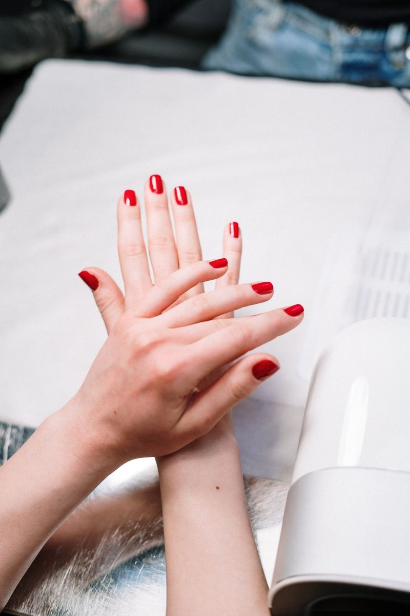 Hands with glossy red gel polish
